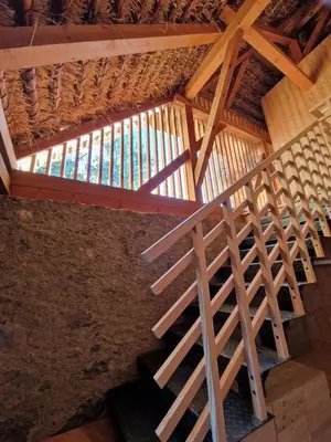 a wooden staircase in a building with a window at OBERBUCHFELDER historic farmhouse in Laion