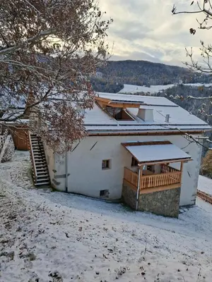 a white house with snow on the roof at OBERBUCHFELDER historic farmhouse in Laion