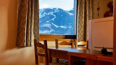 a dining room table with a view of a mountain at Cavalese view in Cavalese