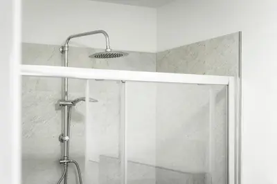 a bathroom with a shower with a glass door at B&B Casa Nadia in Tesero