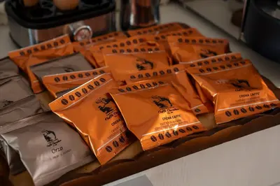 a table topped with orange packets of food at B&B Casa Nadia in Tesero
