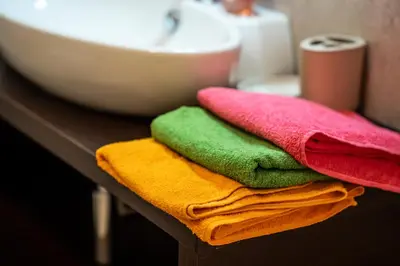 a pile of towels sitting on a counter next to a sink at B&B Casa Nadia in Tesero