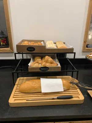 a display of bread and pastries on a table at Dolomites Room and Breakfast Formiè in Vigo di Fassa