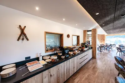 a kitchen with a counter with some food on it at Dolomites Room and Breakfast Formiè in Vigo di Fassa