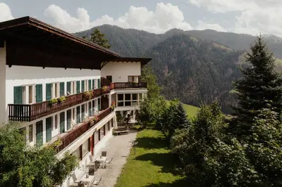 a building with a view of a mountain at Pension Torr in San Martino in Badia