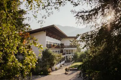 a large white building with a roof at Pension Torr in San Martino in Badia