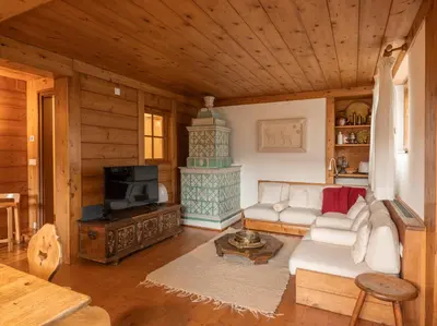 a living room with a couch and a fireplace at Casa La Montanina, a due passi dal centro di Cortina in Cortina dʼAmpezzo