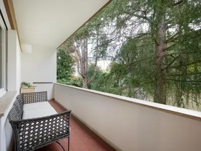 a balcony with a bench and a large window at Central Palm Studio with free Parking in Merano