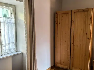 a wooden cabinet in a room with a window at Casa Tone in Predazzo