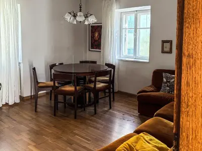 a living room with a dining room table and chairs at Casa Tone in Predazzo