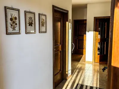 a hallway with three pictures on the wall at Casa Tone in Predazzo