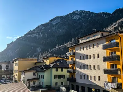 a group of buildings in front of a mountain at Casa Tone in Predazzo