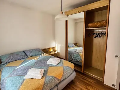 a bedroom with a bed and a large mirror at Casa Tone in Predazzo