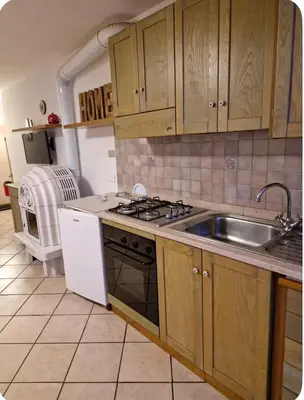 a kitchen with a sink and a stove at Appartamento Villa Lucia in Moena