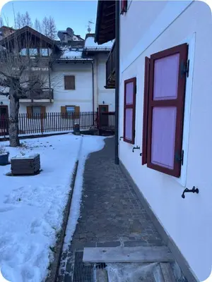 a house with snow on the side of it at Appartamento Villa Lucia in Moena