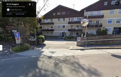 a street sign in front of a large building at Lovely Apartment with pool and garden in Marlengo