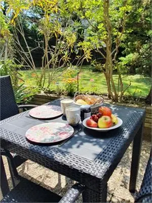 a picnic table with plates of fruit on it at Lovely Apartment with pool and garden in Marlengo