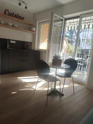 a kitchen with a table and two chairs in a room at Lovely Apartment with pool and garden in Marlengo