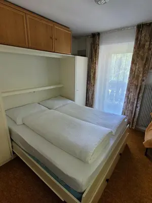 a large bed in a room with a window at Privatzimmer Gassermühle in Eggen