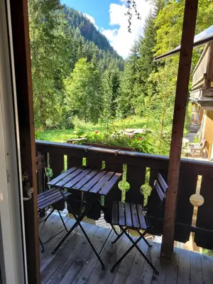 a porch with a bench and a view of a forest at Privatzimmer Gassermühle in Eggen
