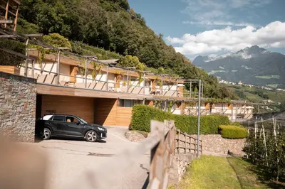 a car parked in front of a house at Pergola Residence in Lagundo