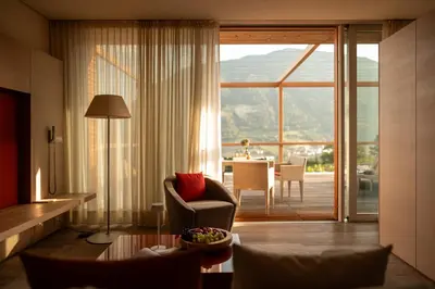 a living room with a couch and a chair and a table at Pergola Residence in Lagundo
