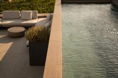 a swimming pool with two lounge chairs next to the water at Pergola Residence in Lagundo