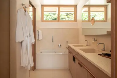 a bathroom with a bath tub and a sink and a bath tubermott at Pergola Residence in Lagundo