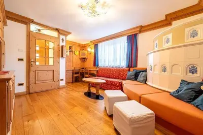 a living room with a couch and a table at Casa di Sere in Pieve di Livinallongo