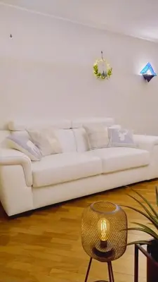 a white couch in a living room with a table at Da NOEMI E MARCO in Cavalese
