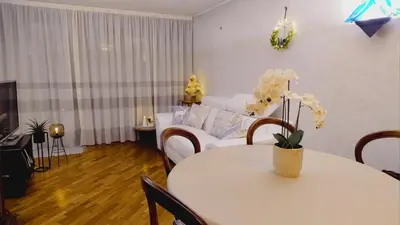 a living room with a white table and a couch at Da NOEMI E MARCO in Cavalese