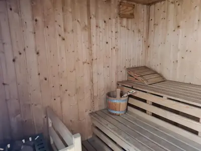 a wooden sauna with a trash can in it at Da NOEMI E MARCO in Cavalese
