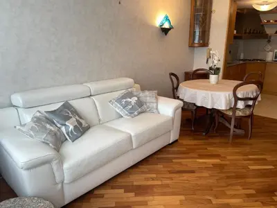 a living room with a white couch and a table at Da NOEMI E MARCO in Cavalese