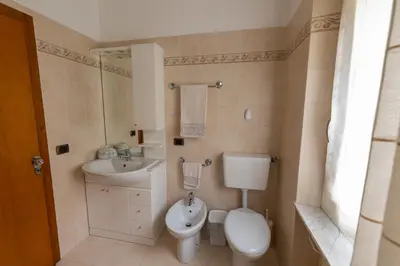 a bathroom with a toilet and a sink at Dolomites Apartment Finestra sul Civetta in Alleghe
