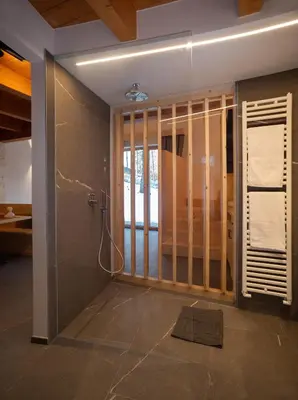 a room with a staircase and a kitchen with a counter at Residence Lavina in Caldaro
