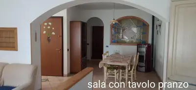a kitchen with a table and a dining room at CasaSandra-Tres-Trentino in Tres