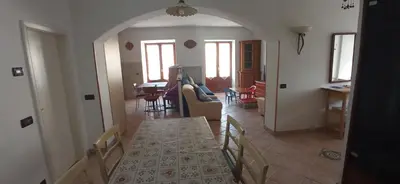a dining room and living room with a table and chairs at CasaSandra-Tres-Trentino in Tres