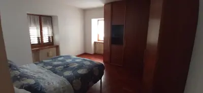 a bedroom with a bed and a dresser and a window at CasaSandra-Tres-Trentino in Tres