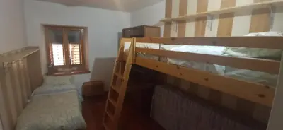 a bedroom with two bunk beds and a window at CasaSandra-Tres-Trentino in Tres