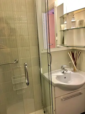 a bathroom with a shower with a sink and a mirror at Camera Alpe di Siusi in Alpe di Siusi