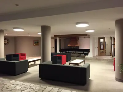 a living room with two couches and a piano at Camera Alpe di Siusi in Alpe di Siusi