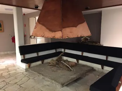 a black bench in a room with a chandelier at Camera Alpe di Siusi in Alpe di Siusi