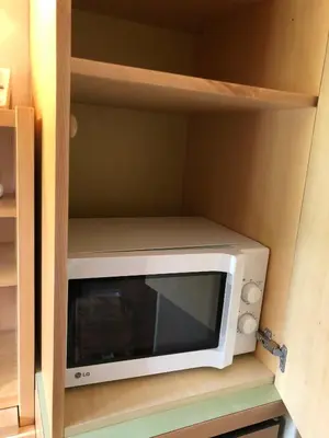 a microwave sitting inside of a kitchen cabinet at Camera Alpe di Siusi in Alpe di Siusi