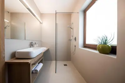a bathroom with a sink and a shower at Weingut Weidlhof - Suite & Breakfast - Vacation for wine lovers in Caldaro