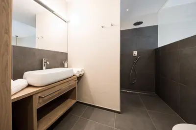a bathroom with a sink and a shower at Weingut Weidlhof - Suite & Breakfast - Vacation for wine lovers in Caldaro