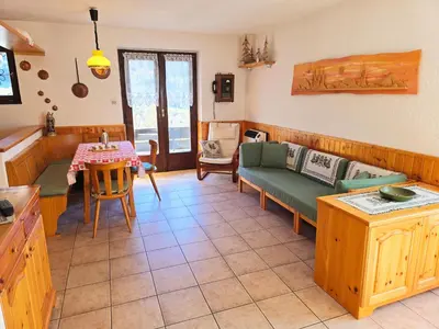 a living room with a couch and a table at Fior di Larice - Alpine Stay Apartments in Ziano di Fiemme