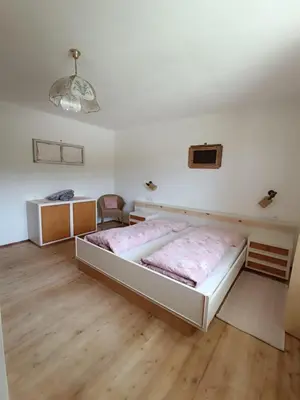 a bedroom with a large bed in a room at Ferienwohnung Marchnerhof in Terento