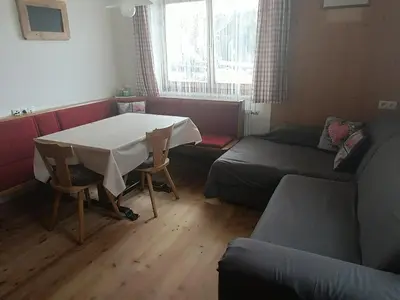 a living room with a table and a couch at Ferienwohnung Marchnerhof in Terento