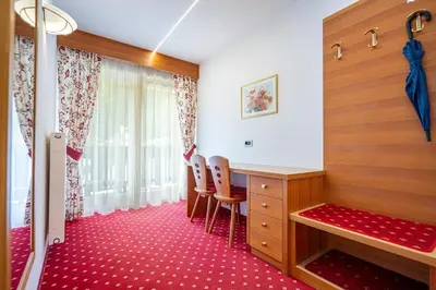 a room with a desk and chairs and a window at Garni Crepaz in Selva di Val Gardena
