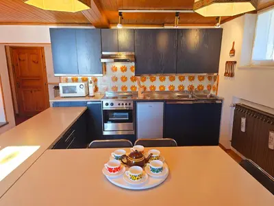 a kitchen with a table with three cups on it at Le Vette di Moena - Alpine Stay Apartments in Moena